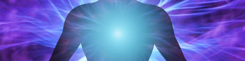 human figure with a glowing chakra and energy halo